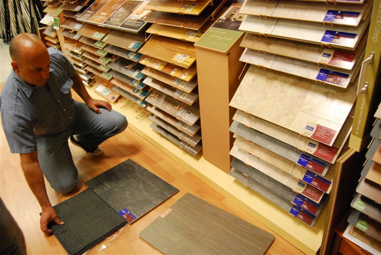 Darlene Horn's husband picking out flooring for their home.