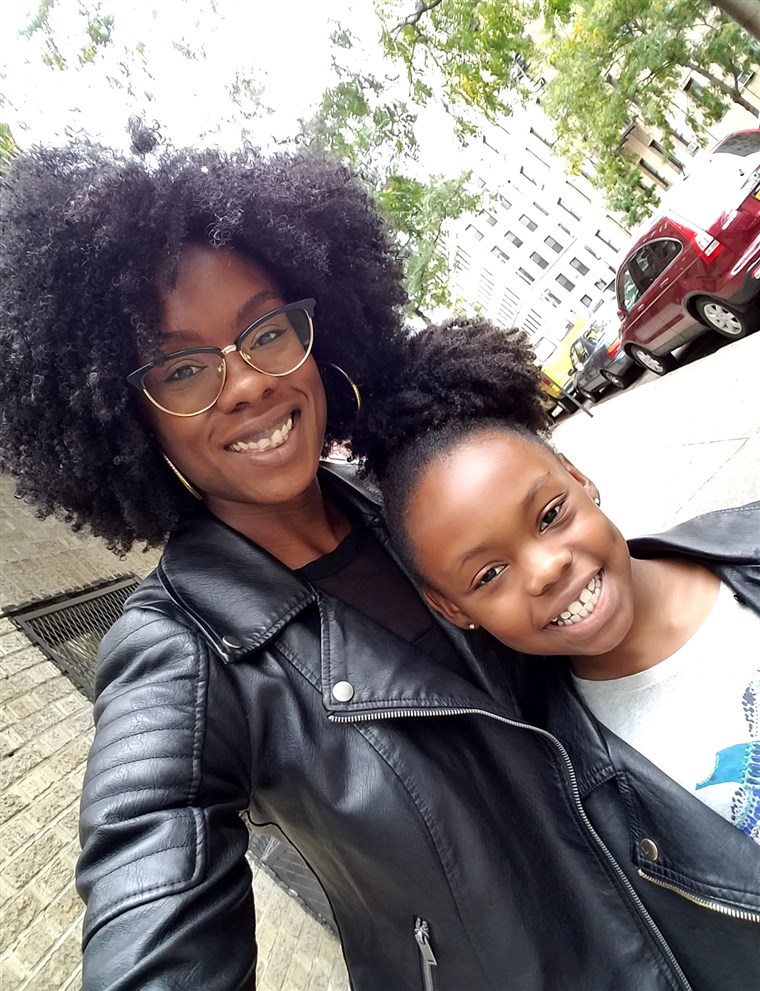 Charles poses with her daughter, who now loves to wear her hair curly just like her mom. 