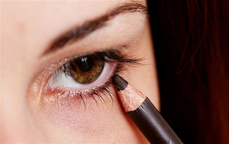 여자 applying eyeliner