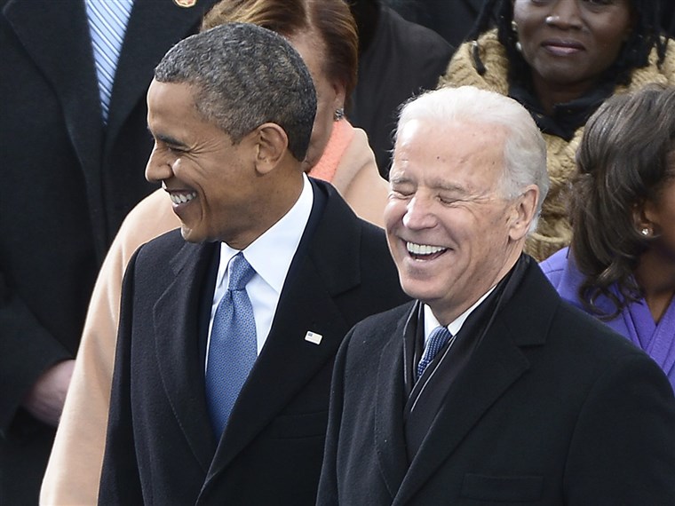 バイデン shares a laugh with President Obama during the inauguration ceremony on the West Front of the US Capitol before Obama is ceremonially sworn in for a second term as the 44th President of the United States.