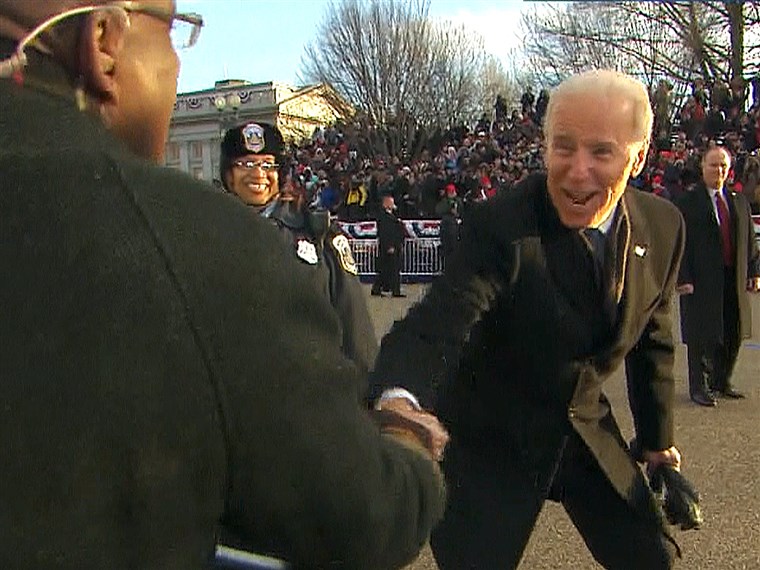 Wakil President Joe Biden shakes hands with Al Roker during the inauguration parade.