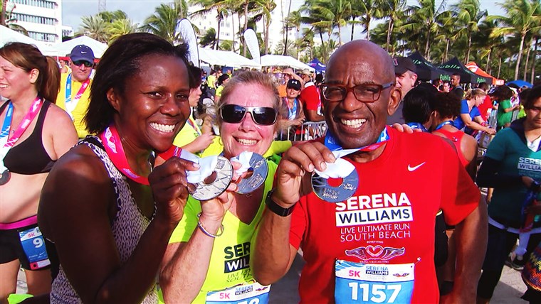 알 Roker and his wife, Deborah, show off their finishing medals with Rothman