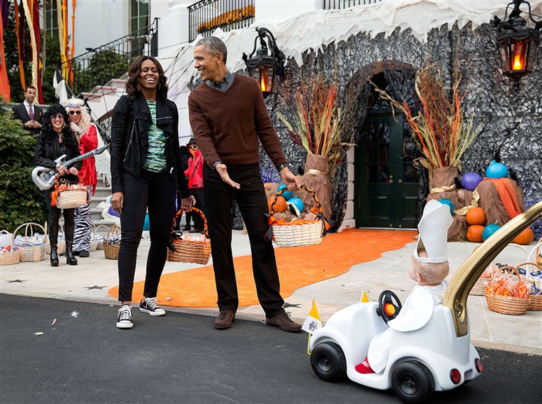 Il president and first lady react to a child in a pope costume and mini popemobile as they welcomed children during a Halloween event on the South Lawn of the White House on Oct. 30, 2015.
