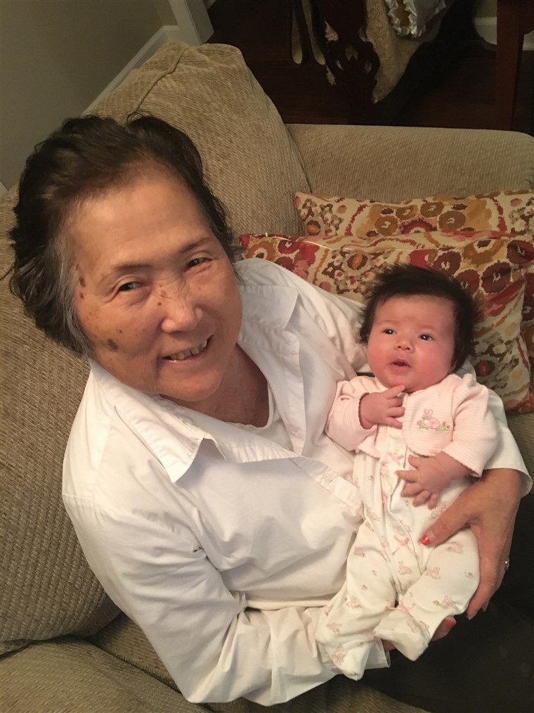 알츠하이머's patient Setsuko Harmon cradles her granddaughter Sadie.