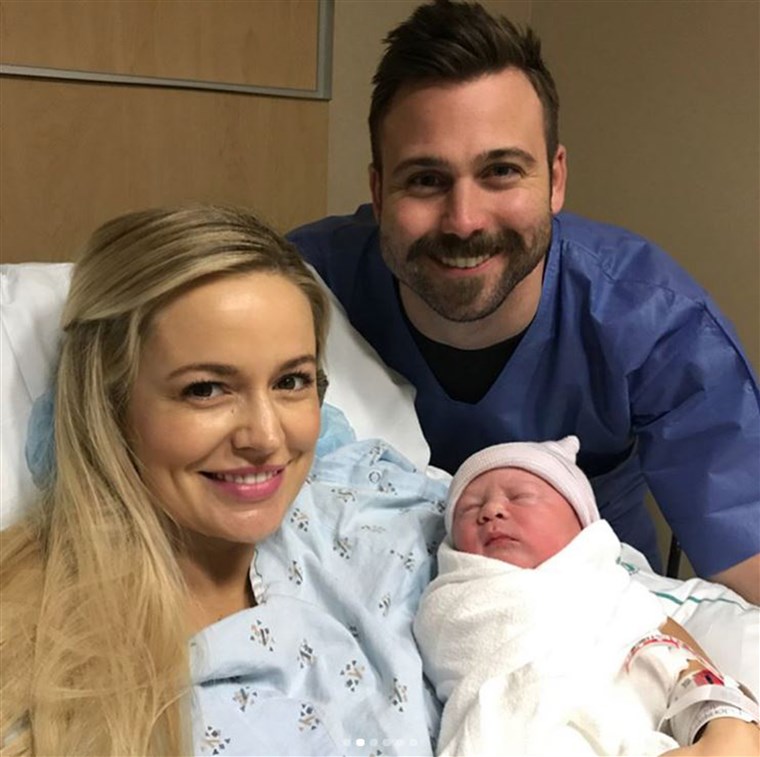 エミリー Maynard and her husband Tyler Johnson pose with their new little boy.