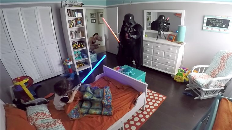 아버지 wakes his son up from nap dressed as Darth Vader