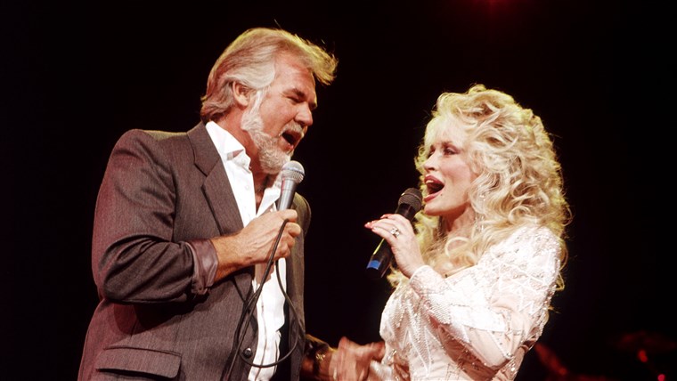 DOLLY PARTON duets with Kenny Rogers in July 1989