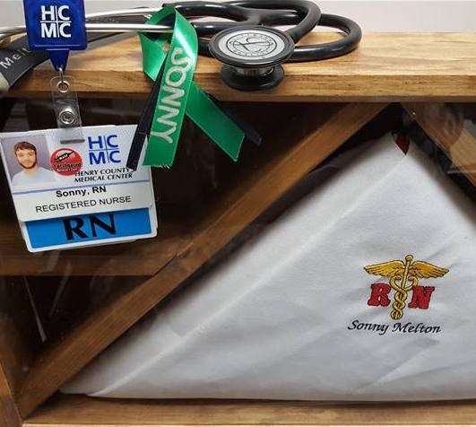 얘야's personal items, including his identification badge for the hospital where he worked as a nurse.