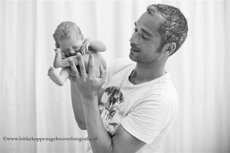 Nikah Fermont's boyfriend Denny holds their newborn daughter. 