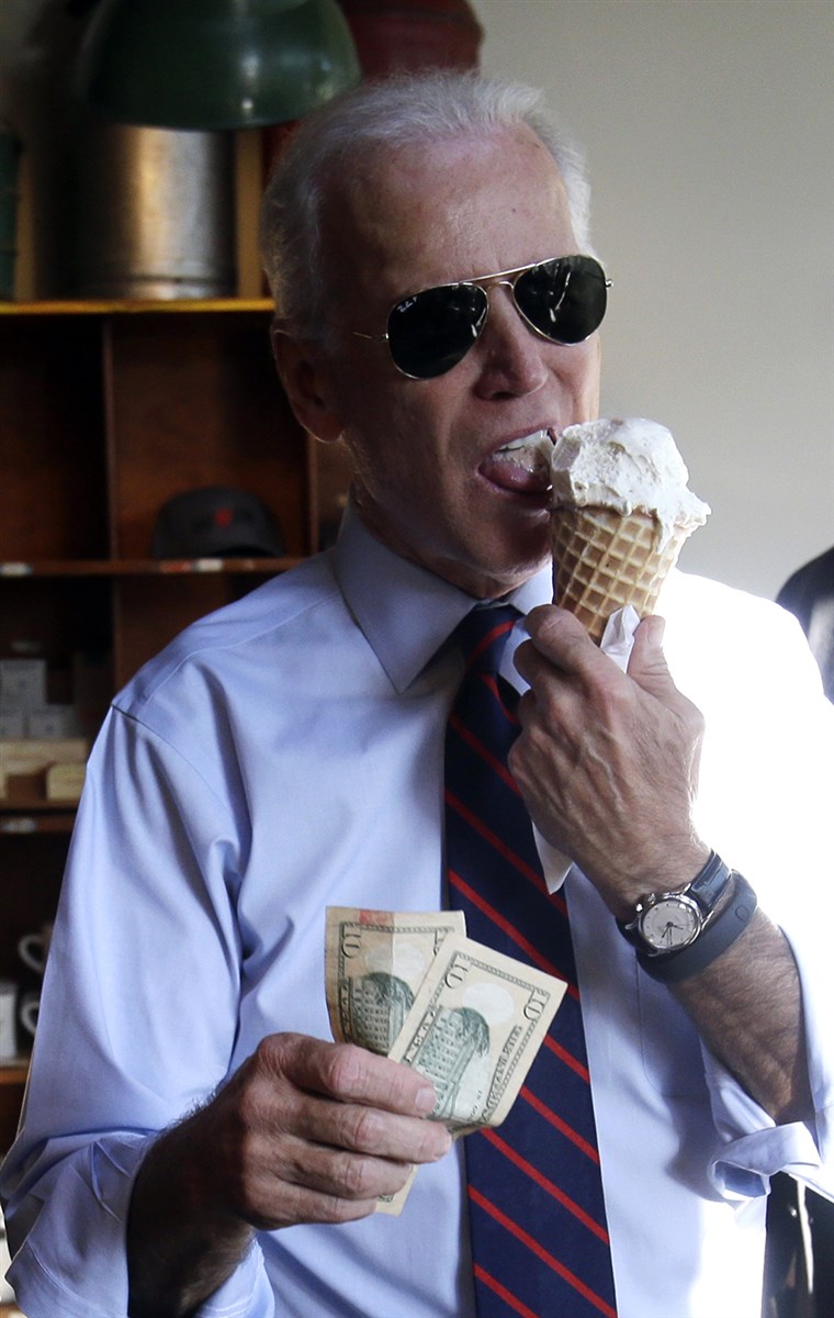 副 President Joe Biden, right, gets ready to pay for an ice cream cone after a campaign rally for U.S. Sen. Jeff Merkley in Portland, Ore., Wednesd...