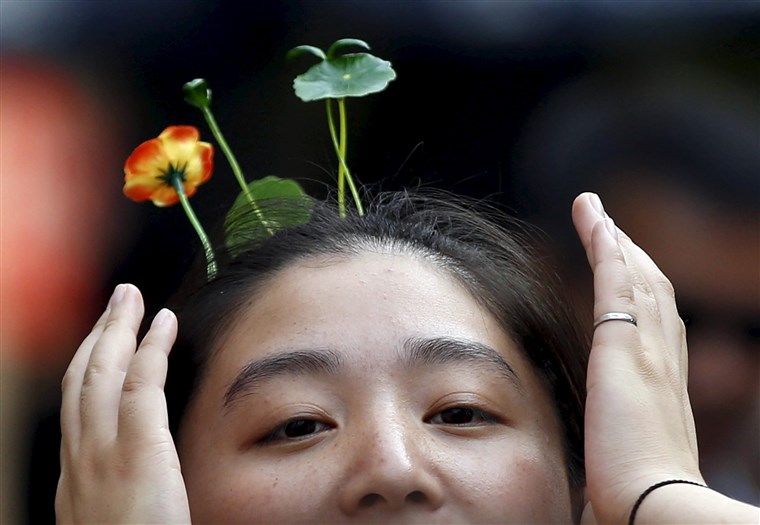 UN woman wearing hairpins in the shape of sprouts and flowers makes her way on Nanluoguxiang street in Beijing