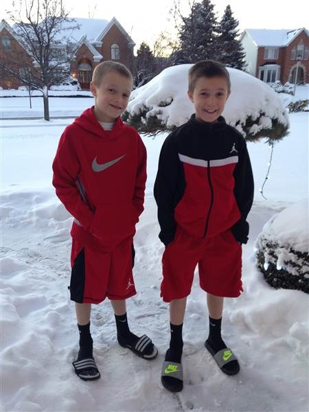 8 살짜리 twins Cameron, left, and Colin Corcoran show off their winter look in snowy Buffalo.