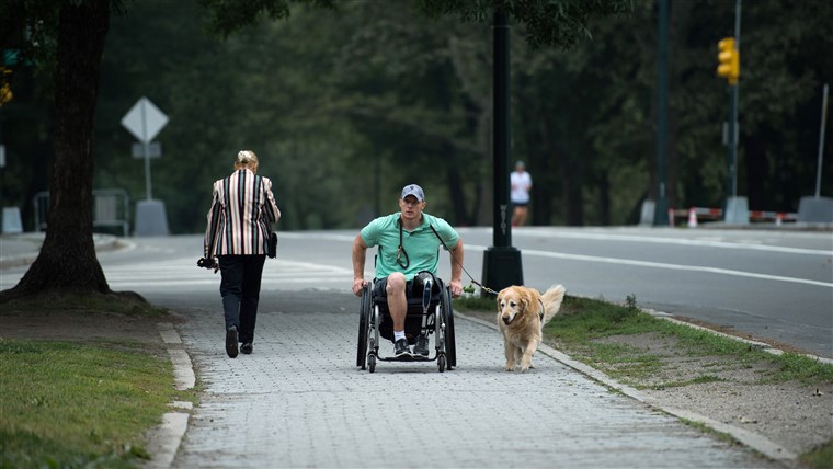 米国。 Navy Corpsman Joe Worley and his service dog, golden retriever Benjamin.