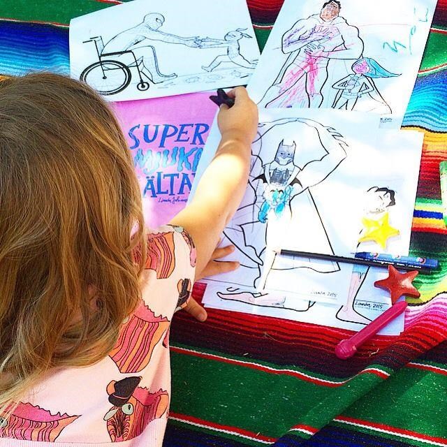 Bambini color drawings that show everything from Batman wearing a baby to Spider-Man in a wheelchair.