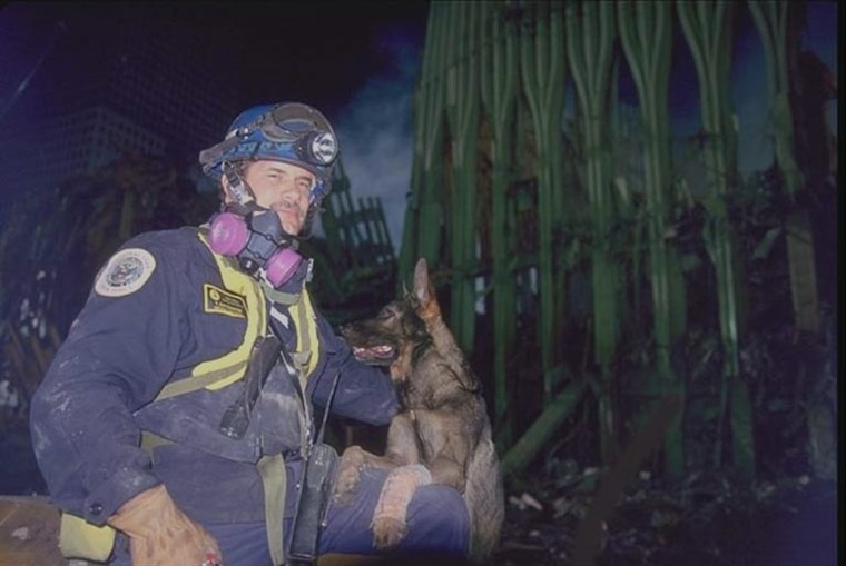 カイザー the search dog and handler Tony Zintsmaster are pictured at the pile at Ground Zero in 2001.