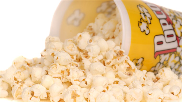 Contenitore of delicious movie popcorn with popcorn spilling out