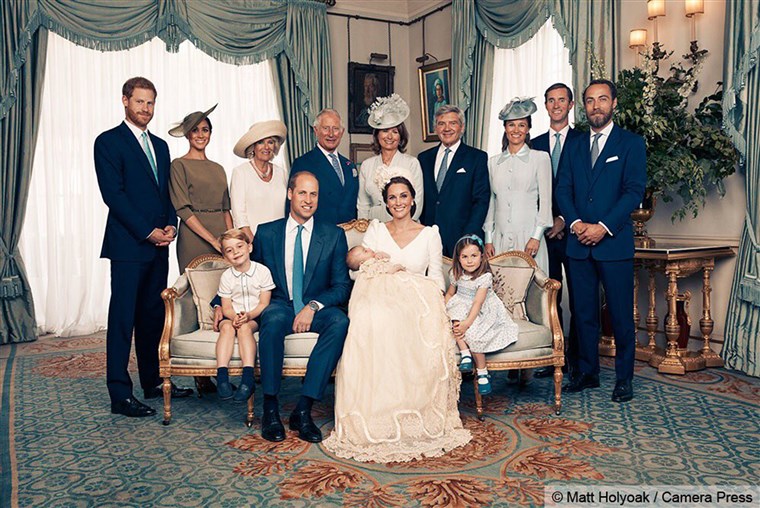 Duduk together (left to right) are Prince George, the Duke of Cambridge, baby Prince Louis, the Duchess of Cambridge and Princess Charlotte. Standing (left to right): The Duke of Sussex, the Duchess of Sussex, the Duchess of Cornwall, the Prince of Wales, Mrs. Carole Middleton, Mr. Michael Middleton, Mrs. Pippa Matthews, Mr. James Matthews and Mr. James Middleton.