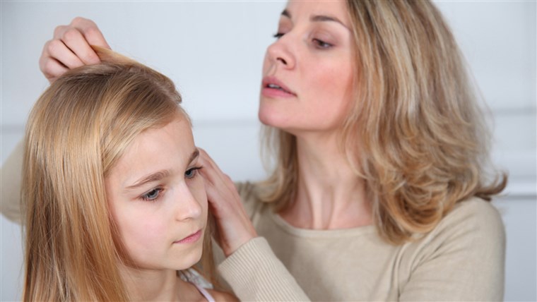 母 treating daughter's hair against lice