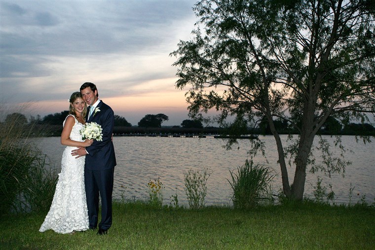ジェナ and her husband, Henry Hager, pose along the lake at Prairie Chapel Ranch following their wedding ceremony on May 10, 2008.