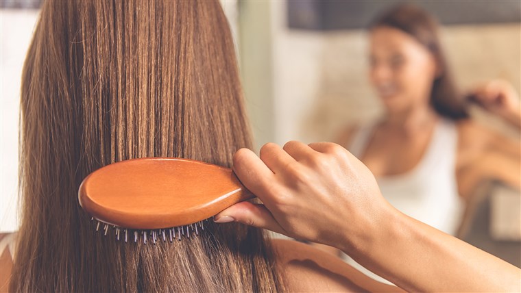 Berkilau Hair - Woman combing her hair.