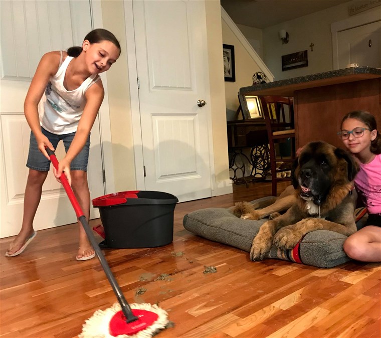 10-year-old Elena and Miranda mopping up muddy footprints