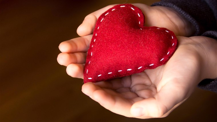 Merah heart in child hands, hand made gift, valentine day and family love concept, close up, horizontal